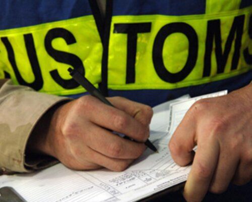 Customs officer checking shipping documents